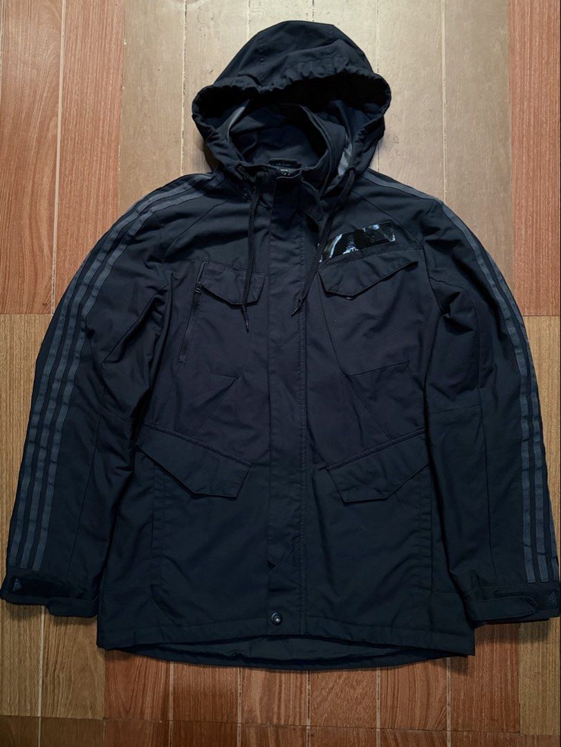 Adidas Black Hooded Jacket with Three Stripes (Category: Coats, Jackets and Outerwear) located in Dasmarinas. Submitted by kylebecker (Listing ID 1467943978, Image 1). Description: - Color: Classic Black - Brand: Adidas - Design: Iconic three stripes down both sleeves - Pockets: Multiple front utility pockets with secure flaps and zippers - Closure: Full zip front covered by a snap button placket - Hood: Adjustable hood with drawstrings - Materia