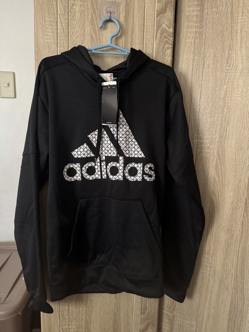 Adidas Black Hoodie with Graphic Logo (Category: Hoodies) located in Baras. Submitted by vale831 (Listing ID 1468024888, Image 1). Description: - Brand new with original store tags still attached - Classic black color with a stylish white geometric pattern inside the front logo - Comfortable drawstring hood and practical front kangaroo pocket - Long sleeves, ideal for workouts or everyday casual wear - Clean and versatile athletic piece.