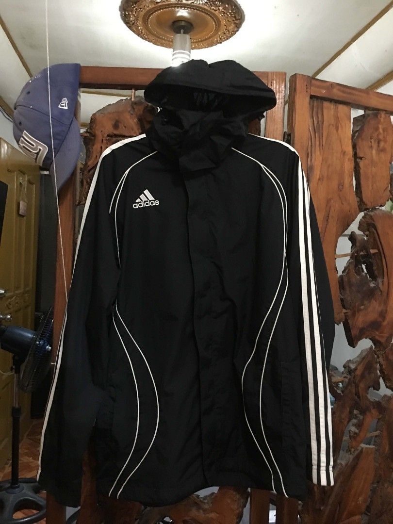 Adidas Black Windbreaker Jacket (Category: Coats, Jackets and Outerwear) located in Manila. Submitted by teo.curated (Listing ID 1467994017, Image 2). Description: Black Adidas windbreaker jacket with a built-in hood. Classic white three stripes down the sleeves plus piping details on the front and back. Full zip front closure. Lightweight material, great outer layer for workouts or daily casual wear. Back features a small white graphic logo near