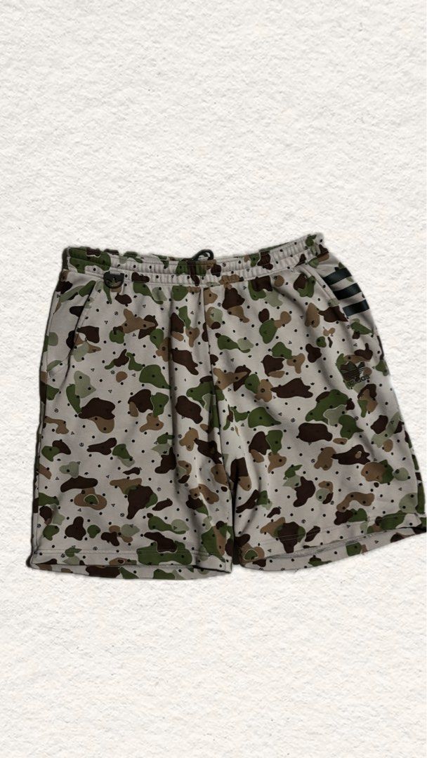 Adidas Camouflage Print Athletic Shorts (Category: Shorts) located in General Santos City (Dadiangas). Submitted by choco_apparel (Listing ID 1467842402, Image 1). Description: - Brand: Adidas - Design: All-over camouflage pattern (Light grey base with green and brown spots) - Waistband: Elastic with adjustable drawstring closure - Details: Classic 3 black stripes on the left hem with small embroidered Adidas trefoil logo - Pockets: Convenient si