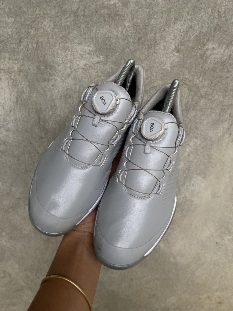 Adidas Golf Shoes with BOA Lacing System (Category: Golf) located in Manila. Submitted by clevermountain_9c1516 (Listing ID 1467910310, Image 3). Description: - Brand: Adidas - Color: Grey with subtle silver accents - Closure: BOA lacing dial system for quick, easy adjustments - Midsole: Responsive Boost foam for all-day comfort - Outsole: Spiked for superior grip and stability on the course - Condition: Minor dirt on soles from previous rounds o