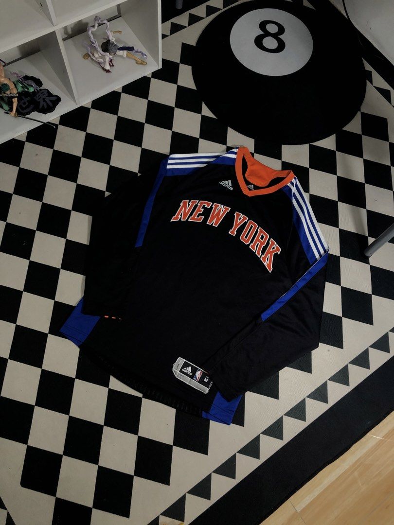Adidas Jersey Black Size Medium. Dimes: 20X29 (Category: Activewear) located in Manila. Submitted by ejaay_2012 (Listing ID 1467867455, Image 2). Description: - Brand: Adidas - Team: New York Knicks - Style: Long sleeve basketball jersey / streetwear - Colorway: Black, orange, and blue - Size: Medium (M) - Details: Classic chest graphics, collar branding, and NBA ClimaCool hem tag - Origin: Made in Thailand - Condition: Good weight and quality.