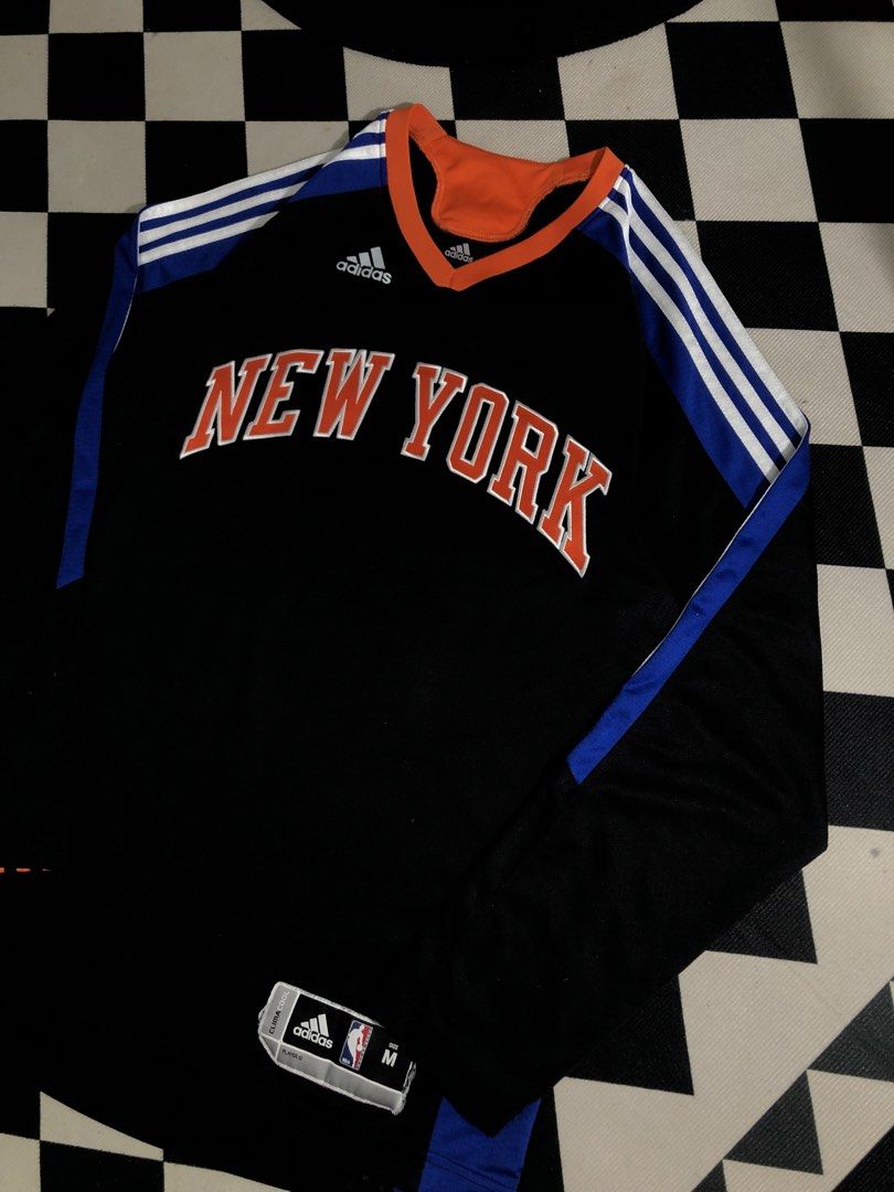 Adidas Jersey Black Size Medium. Dimes: 20X29 (Category: Activewear) located in Manila. Submitted by ejaay_2012 (Listing ID 1467867455, Image 3). Description: - Brand: Adidas - Team: New York Knicks - Style: Long sleeve basketball jersey / streetwear - Colorway: Black, orange, and blue - Size: Medium (M) - Details: Classic chest graphics, collar branding, and NBA ClimaCool hem tag - Origin: Made in Thailand - Condition: Good weight and quality.