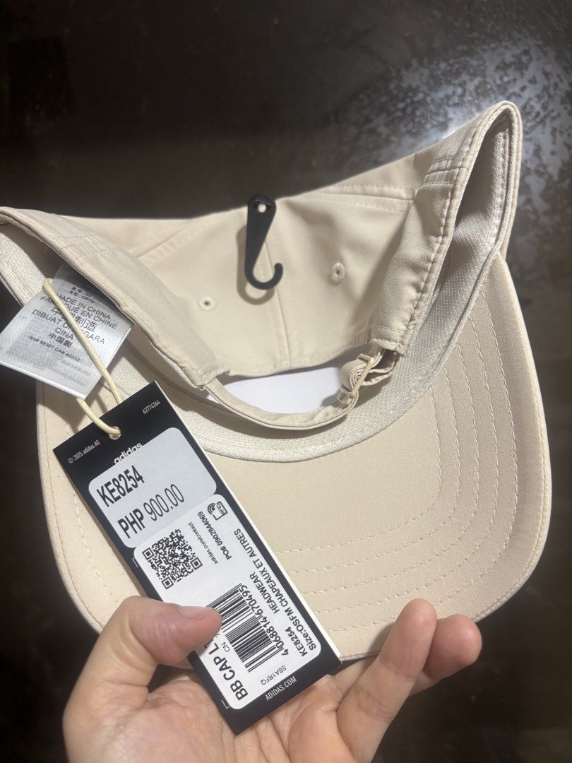 Adidas Lightweight Baseball Cap Beige OSFM (Category: Caps & Hats) located in Makati City. Submitted by shelfdestash (Listing ID 1467917021, Image 2). Description: - Brand: Adidas - Color: Classic Beige - Condition: Brand new with original store tags attached, unworn - Material: Lightweight and comfortable - Features: Stylish metal brand logo plate on the side - Closure: Adjustable strapback for a custom fit - Sizing: One size fits most.