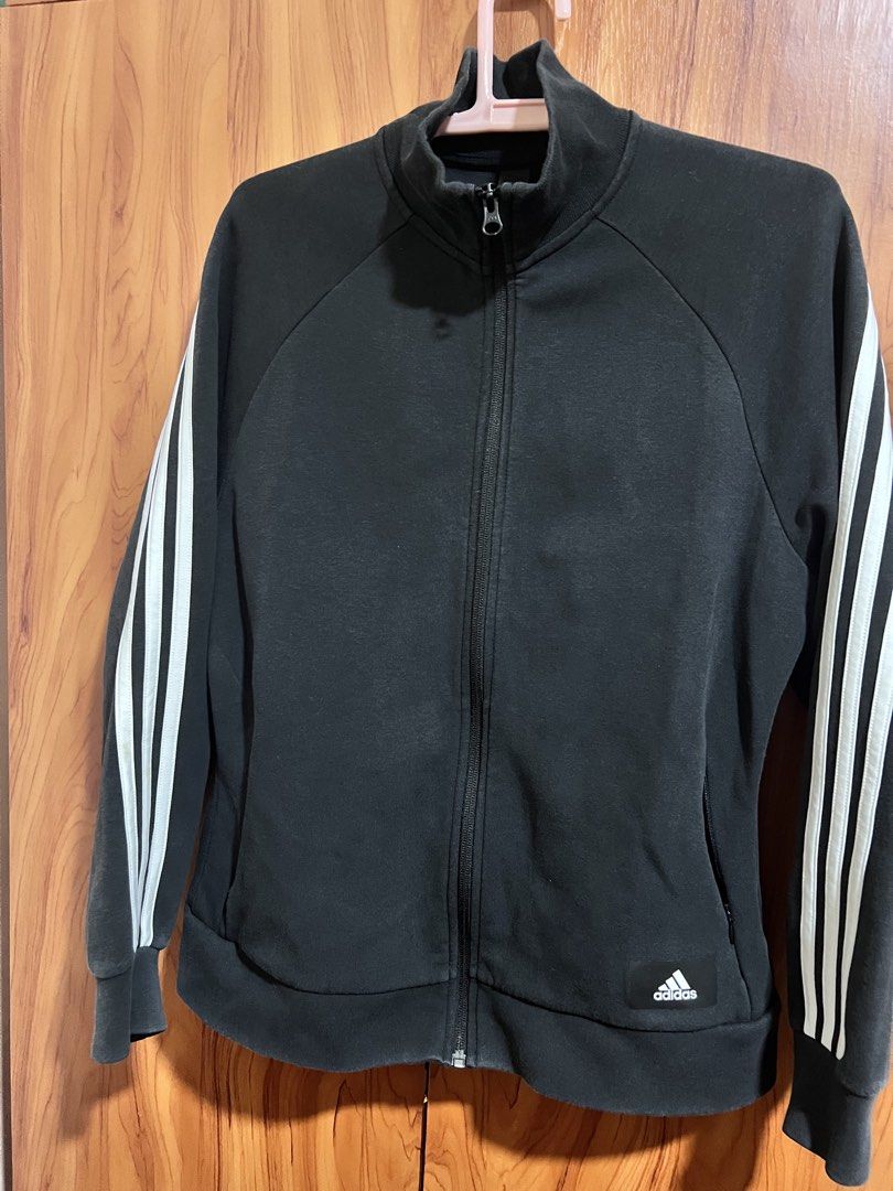 Adidas Primegreen Black Track Jacket (Category: Coats, Jackets and Outerwear) located in Manila. Submitted by wardrobeinmnl (Listing ID 1467888922, Image 1). Description: - Brand: Adidas - Style: Primegreen Track Jacket - Color: Black with white 3-stripe detailing - Size: Small (Regular fit) - Features: Full zip closure, stand-up collar, secure zippered side pockets, and white Adidas logo patch near the hem - Origin: Made in Cambodia - Perfect fo