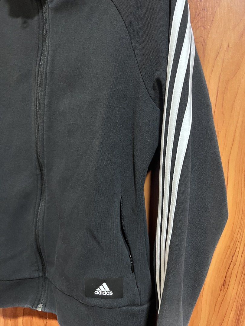 Adidas Primegreen Black Track Jacket (Category: Coats, Jackets and Outerwear) located in Manila. Submitted by wardrobeinmnl (Listing ID 1467888922, Image 2). Description: - Brand: Adidas - Style: Primegreen Track Jacket - Color: Black with white 3-stripe detailing - Size: Small (Regular fit) - Features: Full zip closure, stand-up collar, secure zippered side pockets, and white Adidas logo patch near the hem - Origin: Made in Cambodia - Perfect fo