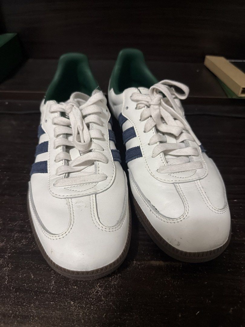 Adidas Samba White Green Size US 10 (Category: Casual Shoes) located in Manila. Submitted by authenticdeclutterer (Listing ID 1468015640, Image 1). Description: - Brand/Model: Adidas (IH4882) - Size: US 10 / UK 9.5 / FR 44 - Colorway: White with green inner lining/heel tab, blue side stripes, and classic gum soles - Manufacture Date & Origin: 09/24, Made in Vietnam - Condition: Worn a few times, slight scuffing near the front toe area - Extras: C