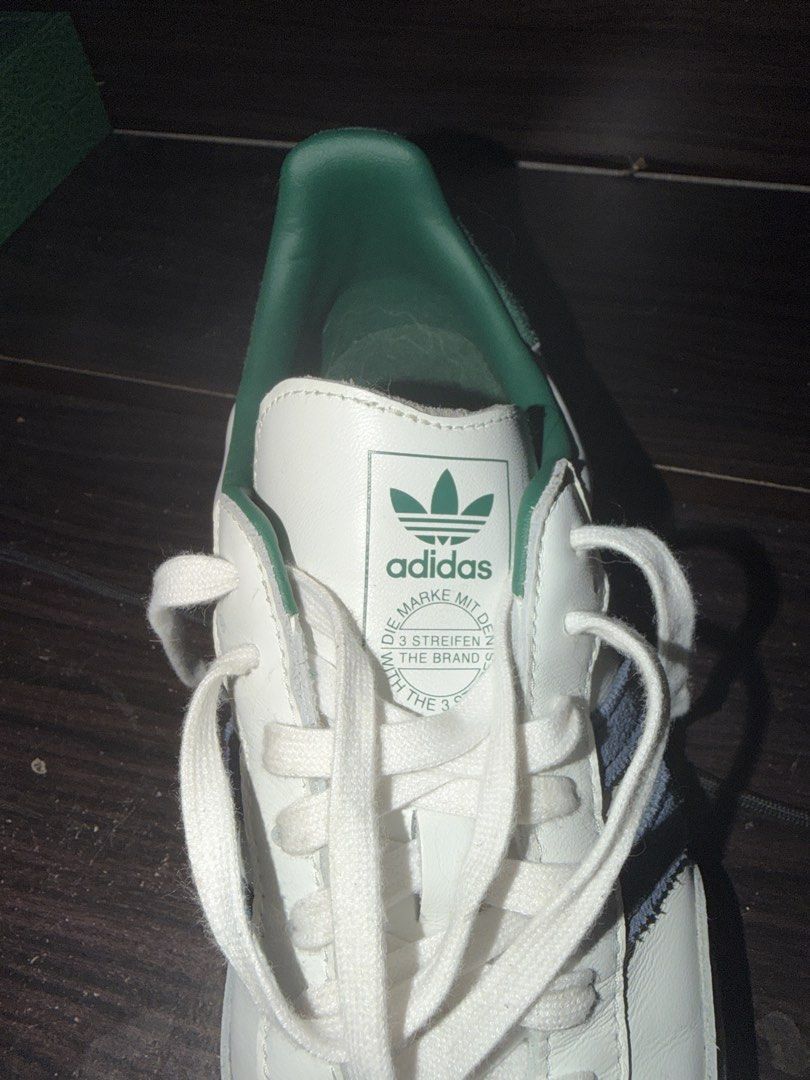 Adidas Samba White Green Size US 10 (Category: Casual Shoes) located in Manila. Submitted by authenticdeclutterer (Listing ID 1468015640, Image 2). Description: - Brand/Model: Adidas (IH4882) - Size: US 10 / UK 9.5 / FR 44 - Colorway: White with green inner lining/heel tab, blue side stripes, and classic gum soles - Manufacture Date & Origin: 09/24, Made in Vietnam - Condition: Worn a few times, slight scuffing near the front toe area - Extras: C