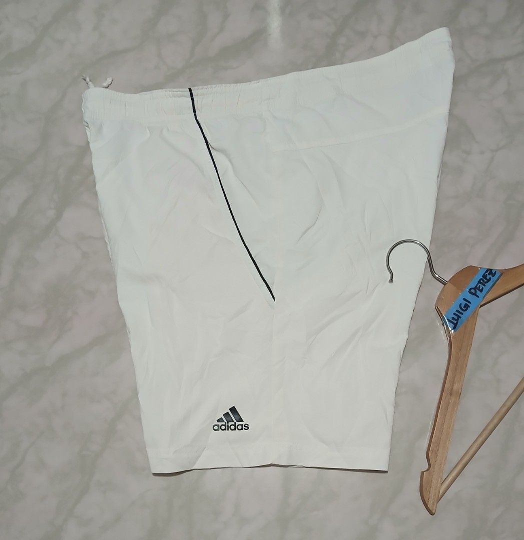Adidas Sequential 9" Bermuda Tennis Shorts White Large (Category: Shorts) located in Plaridel. Submitted by igieperez147282 (Listing ID 1467987325, Image 3). Description: - Brand: Adidas - Item: Bermuda Tennis Shorts - Color: White with black details - Size: Large (Waist: 34-36", Length: 17.5") - Waistband: Elastic with adjustable drawstring - Features: Lightweight fabric, front pockets with black piping, printed Adidas logo near hem - Condition:
