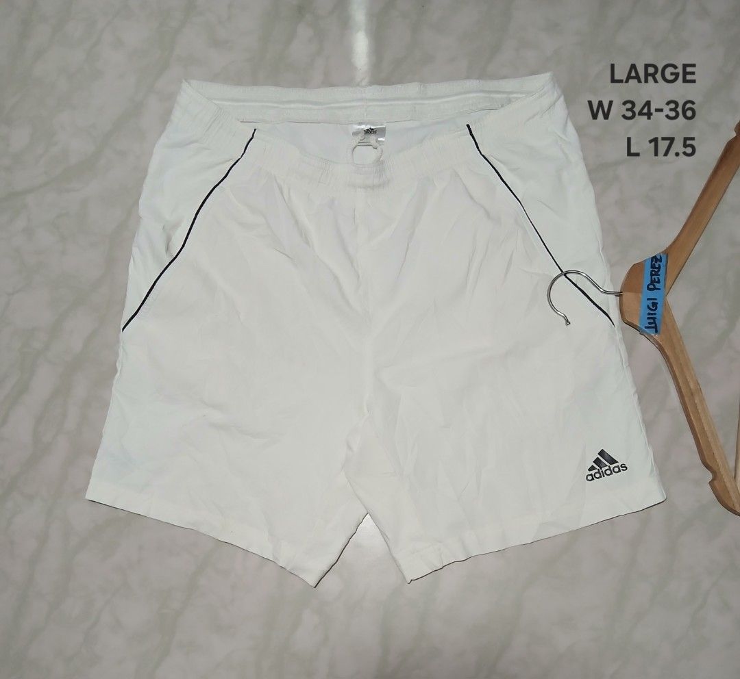 Adidas Sequential 9" Bermuda Tennis Shorts White Large (Category: Shorts) located in Plaridel. Submitted by igieperez147282 (Listing ID 1467987325, Image 1). Description: - Brand: Adidas - Item: Bermuda Tennis Shorts - Color: White with black details - Size: Large (Waist: 34-36", Length: 17.5") - Waistband: Elastic with adjustable drawstring - Features: Lightweight fabric, front pockets with black piping, printed Adidas logo near hem - Condition: