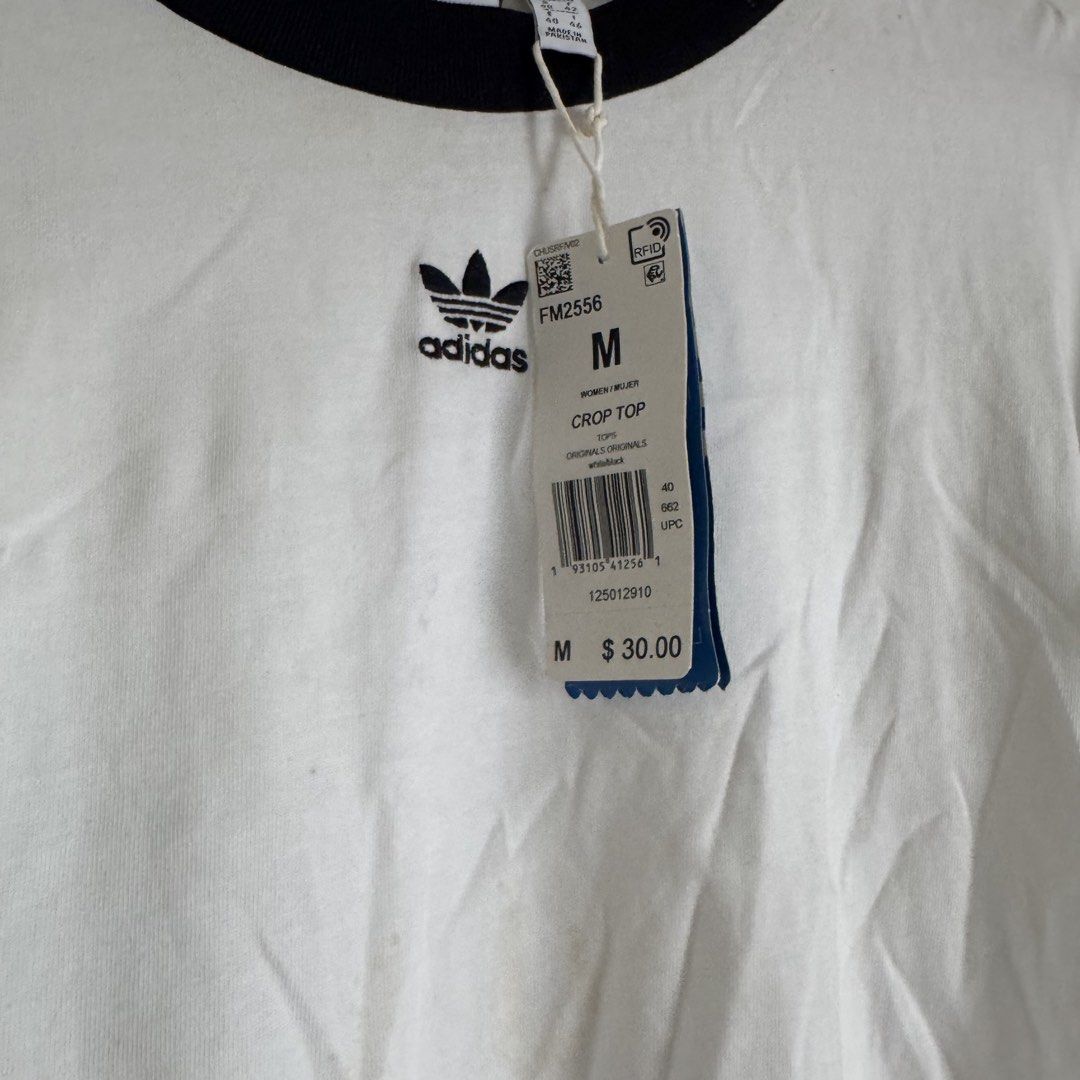 Adidas shirt (Category: Blouses) located in Manila. Submitted by apparella.ph (Listing ID 1467839939, Image 2). Description: Selling low Got it pa sa u.s for $30 + tax Na stock lng sa cabinet. Doesn’t fit me anymore has minimal stain,removable(kayo nlng po maglaba. Check last pic ) Bust.38 Length:19 ☑️Everything is my Own preloved / BNWT/BNWOT ☑️ not thrifted/Ukay ☑️ malukot sa picture kasi na stock sa cabinet (tinatamad mag plantsa ✌️ ) ☑️Person