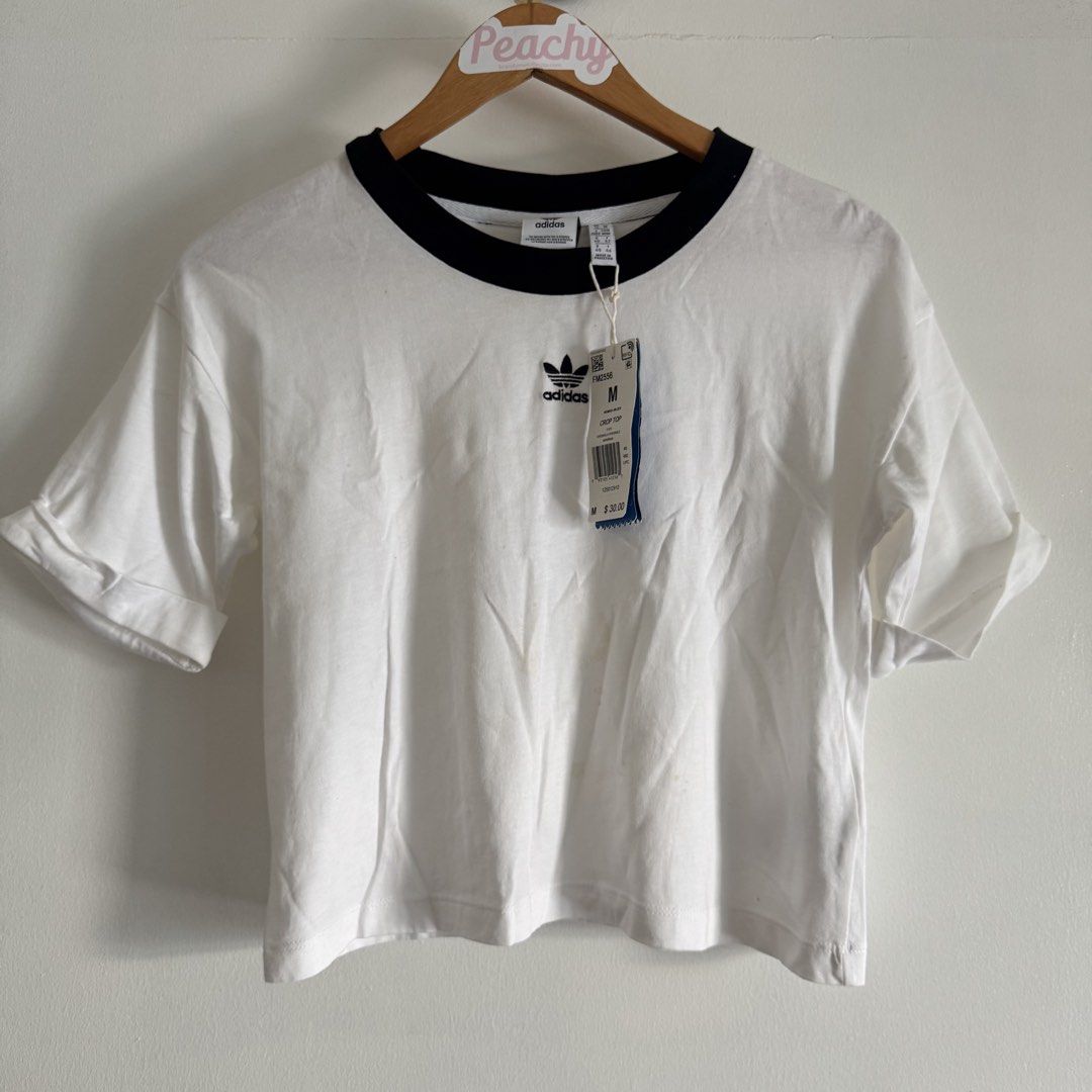 Adidas shirt (Category: Blouses) located in Manila. Submitted by apparella.ph (Listing ID 1467839939, Image 1). Description: Selling low Got it pa sa u.s for $30 + tax Na stock lng sa cabinet. Doesn’t fit me anymore has minimal stain,removable(kayo nlng po maglaba. Check last pic ) Bust.38 Length:19 ☑️Everything is my Own preloved / BNWT/BNWOT ☑️ not thrifted/Ukay ☑️ malukot sa picture kasi na stock sa cabinet (tinatamad mag plantsa ✌️ ) ☑️Person