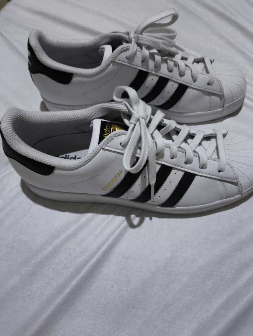 Adidas Superstar 1 White/Black Sneakers (Category: Casual Shoes) located in Manila. Submitted by santlslma (Listing ID 1467954973, Image 2). Description: - DM to inquire for meetups - Original (from Greece) - Used only once(1) since bought - Classic Adidas Superstar sneakers in white leather - Iconic black stripes, heel patch, and shell toe design - Elegant gold foil branding on tongue and side - Includes clean white laces - Versatile everyday ca