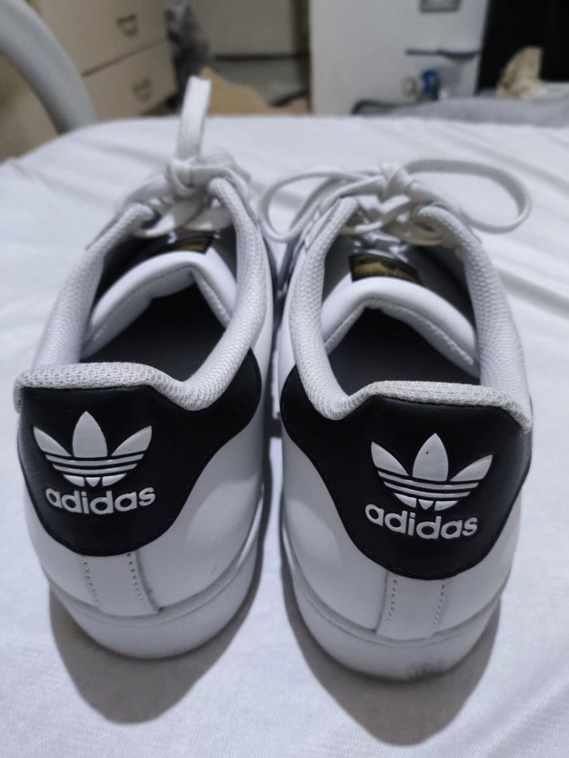 Adidas Superstar 1 White/Black Sneakers (Category: Casual Shoes) located in Manila. Submitted by santlslma (Listing ID 1467954973, Image 3). Description: - DM to inquire for meetups - Original (from Greece) - Used only once(1) since bought - Classic Adidas Superstar sneakers in white leather - Iconic black stripes, heel patch, and shell toe design - Elegant gold foil branding on tongue and side - Includes clean white laces - Versatile everyday ca