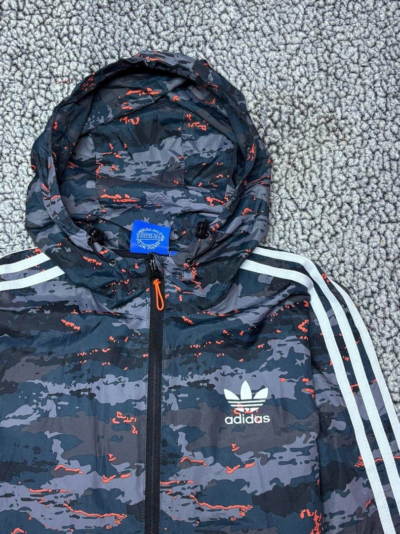 Adidas Three Stripes Camouflage Windbreaker (Category: Hoodies) located in Tayabas. Submitted by retro.rags69 (Listing ID 1467846923, Image 2). Description: • Excellent condition • Color rate: 9.5/10 • width: 21 • length: 26 • No Issue • Printed Logo Design • Camouflage Colorway • Best Fit: Medium.