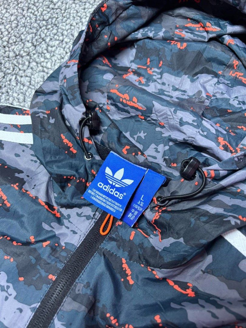 Adidas Three Stripes Camouflage Windbreaker (Category: Hoodies) located in Tayabas. Submitted by retro.rags69 (Listing ID 1467846923, Image 3). Description: • Excellent condition • Color rate: 9.5/10 • width: 21 • length: 26 • No Issue • Printed Logo Design • Camouflage Colorway • Best Fit: Medium.