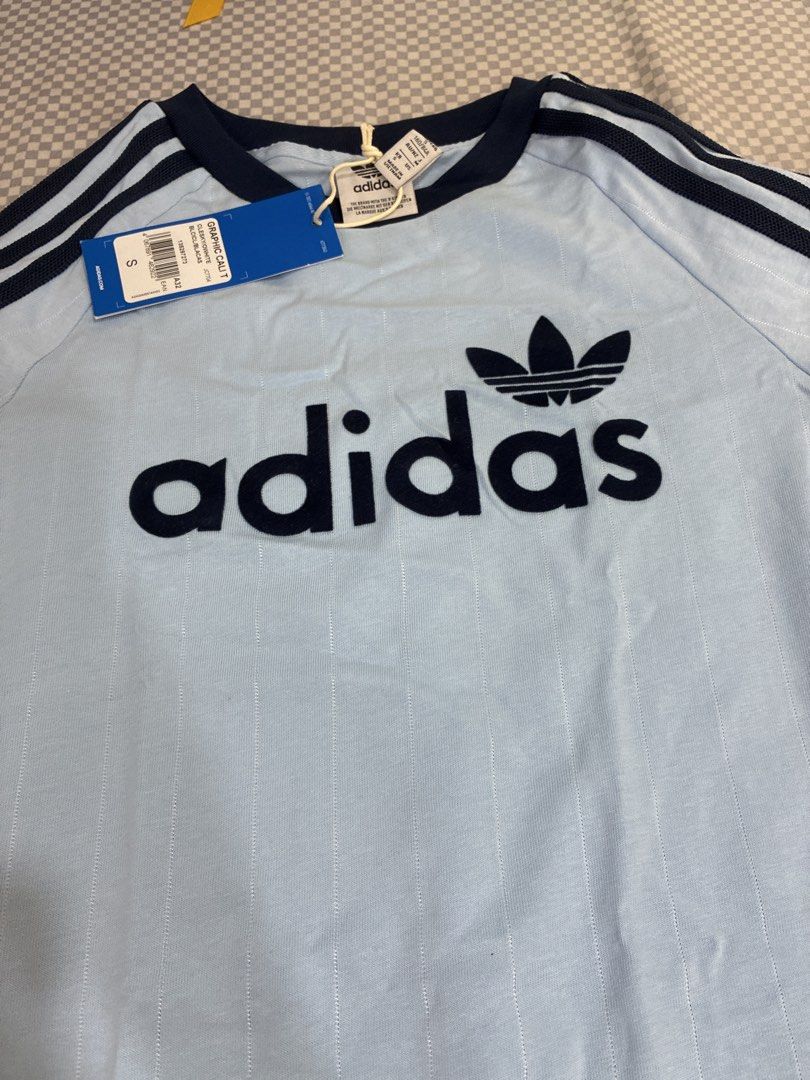 Adidas T-Shirt Light Blue (Category: Tshirts & Polo Shirts ) located in Manila. Submitted by shopmyclothesguys (Listing ID 1467919129, Image 2). Description: - Brand: Adidas - Color: Light blue with dark blue ribbed collar and shoulder stripes - Design: Big Adidas wordmark logo on front chest - Size: Small (S) - Condition: Brand new with original retail tags attached.