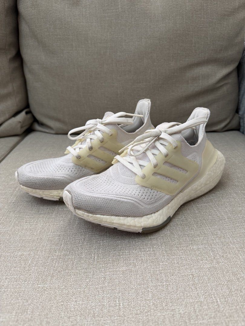 Adidas Ultraboost 21 Cloud White Running Shoes (Category: Sneakers) located in Quezon City. Submitted by babybubots (Listing ID 1467930949, Image 2). Description: - Brand/Model: Adidas Ultraboost Running Shoes - Colorway: White / Warm Vanilla - Features: Primeknit upper, responsive boost midsole, translucent lace cage, gum rubber outsole - Condition: Lightly used, minor dirt on soles and light scuffing on the heel counter (plenty of life left) - 