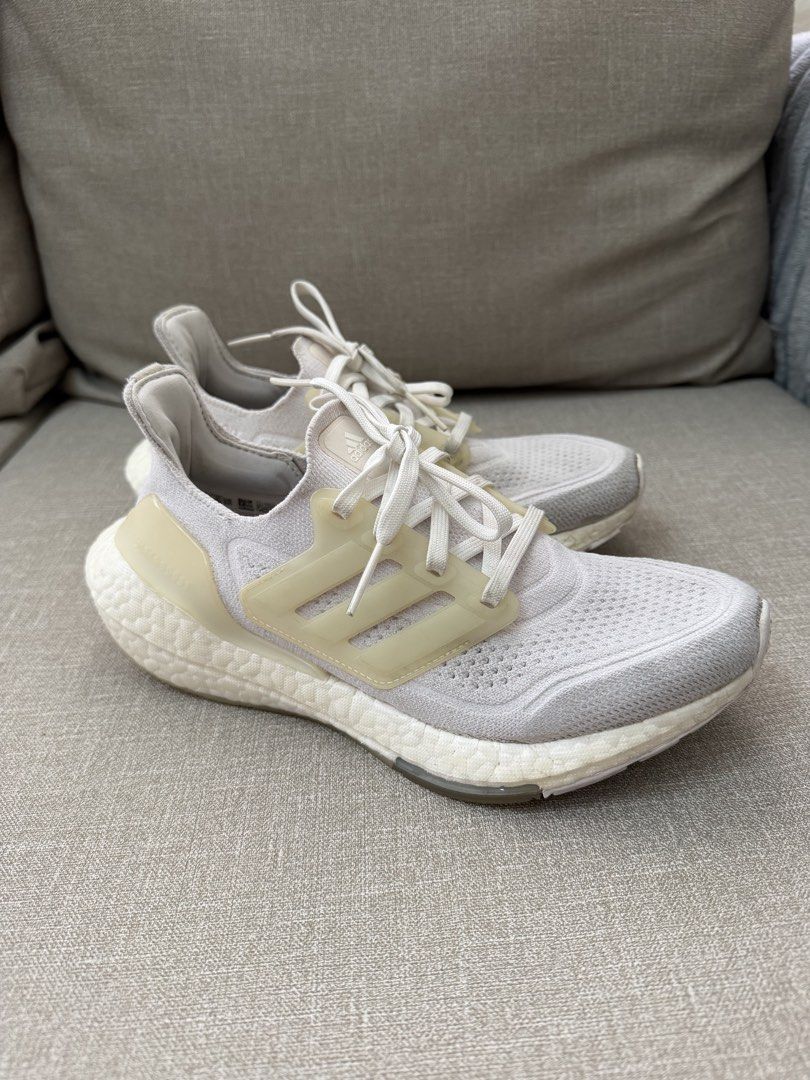 Adidas Ultraboost 21 Cloud White Running Shoes (Category: Sneakers) located in Quezon City. Submitted by babybubots (Listing ID 1467930949, Image 1). Description: - Brand/Model: Adidas Ultraboost Running Shoes - Colorway: White / Warm Vanilla - Features: Primeknit upper, responsive boost midsole, translucent lace cage, gum rubber outsole - Condition: Lightly used, minor dirt on soles and light scuffing on the heel counter (plenty of life left) - 