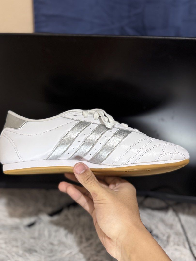 Adidas White and Silver Sneakers (Category: Sneakers) located in Manila. Submitted by keendog_e47ca3 (Listing ID 1467914304, Image 1). Description: - Style: Classic low-top sneakers with quilted toe stitching - Colorway: White leather with metallic silver stripes and heel tab - Sole: Durable gum rubber outsole - Inclusions: Comes with white laces - Best for: Comfortable daily wear.