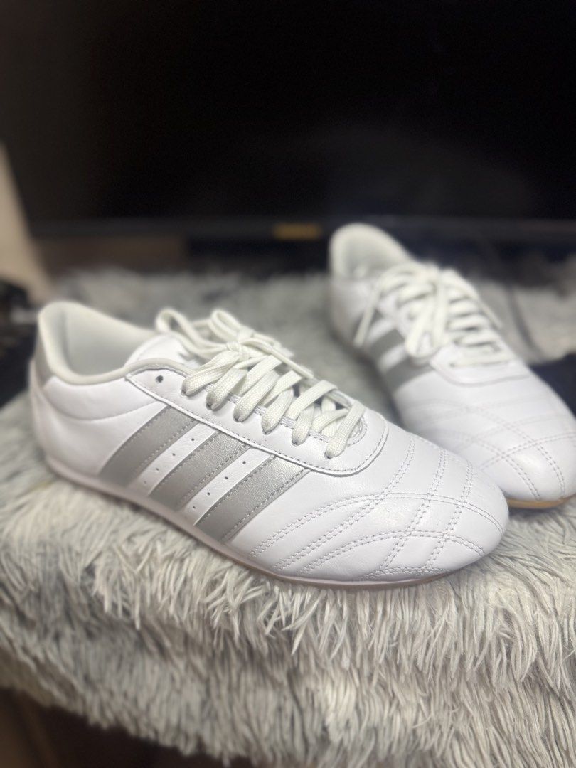 Adidas White and Silver Sneakers (Category: Sneakers) located in Manila. Submitted by keendog_e47ca3 (Listing ID 1467914304, Image 2). Description: - Style: Classic low-top sneakers with quilted toe stitching - Colorway: White leather with metallic silver stripes and heel tab - Sole: Durable gum rubber outsole - Inclusions: Comes with white laces - Best for: Comfortable daily wear.