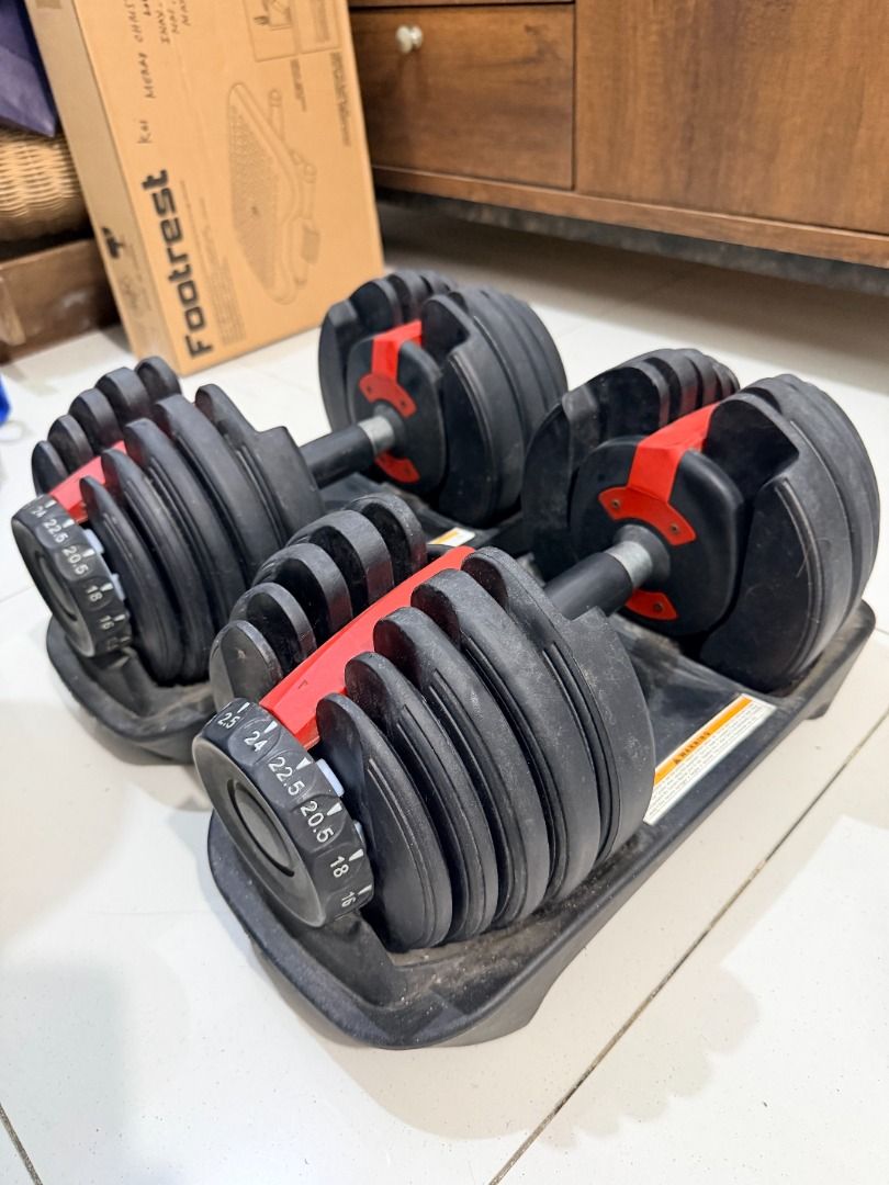 Adjustable Dumbbells Set with Trays (Category: Weights & Dumbbells) located in Quezon City. Submitted by 30somethingtreasures (Listing ID 1468003911, Image 3). Description: - Pair of adjustable dumbbells with black plates and striking red locking mechanisms - Easy weight selection via clearly marked dials ranging from 2.5 up to 24kg - Includes matching storage trays for safe and neat organization - Smooth-working adjustment mechanism for quick we