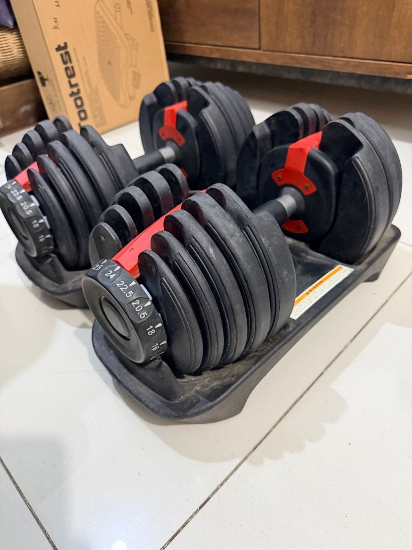 Adjustable Dumbbells Set with Trays (Category: Weights & Dumbbells) located in Quezon City. Submitted by 30somethingtreasures (Listing ID 1468003911, Image 2). Description: - Pair of adjustable dumbbells with black plates and striking red locking mechanisms - Easy weight selection via clearly marked dials ranging from 2.5 up to 24kg - Includes matching storage trays for safe and neat organization - Smooth-working adjustment mechanism for quick we