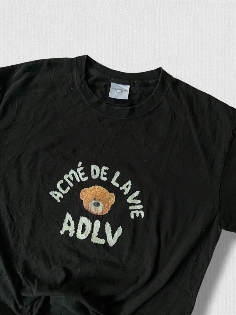 ADLV Bear Print Black T-Shirt (Category: Shirts) located in Cebu City. Submitted by northdrip.threadd (Listing ID 1467903394, Image 2). Description: - Brand: ADLV (Acme De La Vie) - Color: Classic Black - Fit: Relaxed, oversized fit with crew neckline - Design: Small front teddy bear graphic and large back teddy bear print with lettering.