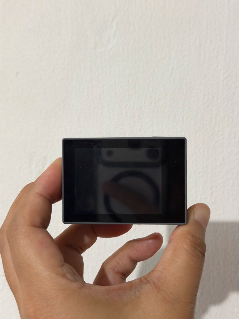 Akaso Brave 4 Pro Action Camera (Category: Cameras) located in Manila. Submitted by kamillega56898 (Listing ID 1467955820, Image 2). Description: Akaso Brave 4 Pro action camera in dark grey. Dual screens setup with front display and main rear touchscreen. Side ports include USB-C and micro SD card slot. Textured body finish for better grip during outdoor recording. Physical buttons on the side and top panels for power, mode selection, and shutte
