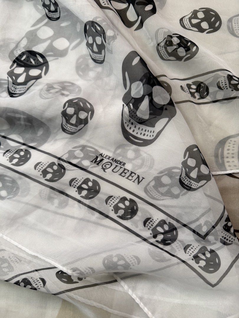 Alexander McQueen White Silk Scarf (Category: Scarves) located in Mabalacat. Submitted by woniebuys (Listing ID 1468059013, Image 2). Description: Alexander McQueen scarf - Repeating skull print design - Lightweight, sheer fabric - Features brand name - Made in Italy - White border with brand name good condition 39x40 inches.