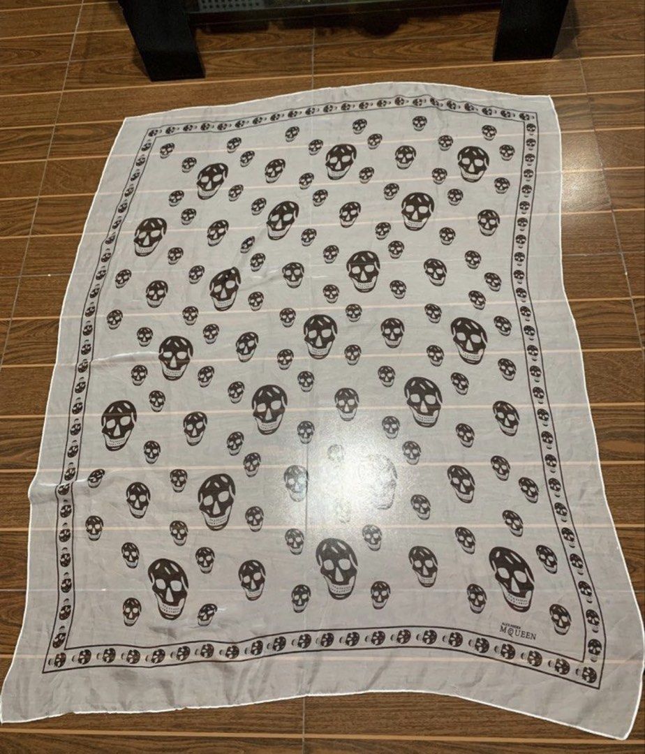 Alexander McQueen White Silk Scarf (Category: Scarves) located in Mabalacat. Submitted by woniebuys (Listing ID 1468059013, Image 1). Description: Alexander McQueen scarf - Repeating skull print design - Lightweight, sheer fabric - Features brand name - Made in Italy - White border with brand name good condition 39x40 inches.