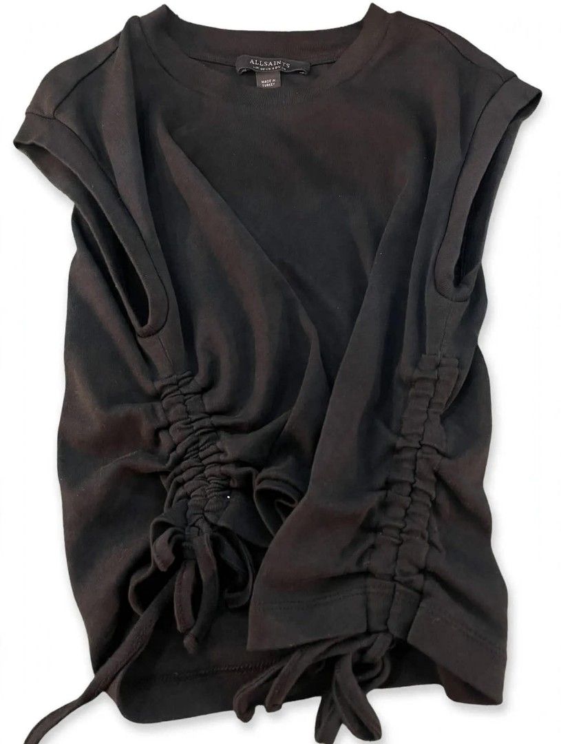 AllSaints Black Sleeveless Top with Side Ruched Drawstrings (Category: Sleeveless) located in Cainta. Submitted by mariss.luxx (Listing ID 1467899173, Image 3). Description: - Brand: AllSaints - Color: Black - Style: Sleeveless top with crew neck - Details: Adjustable ruched drawstrings on both sides with hanging ties, small brand logo on back collar - Origin: Made in Turkey - Condition: Excellent, clean fabric with no stains or damage.