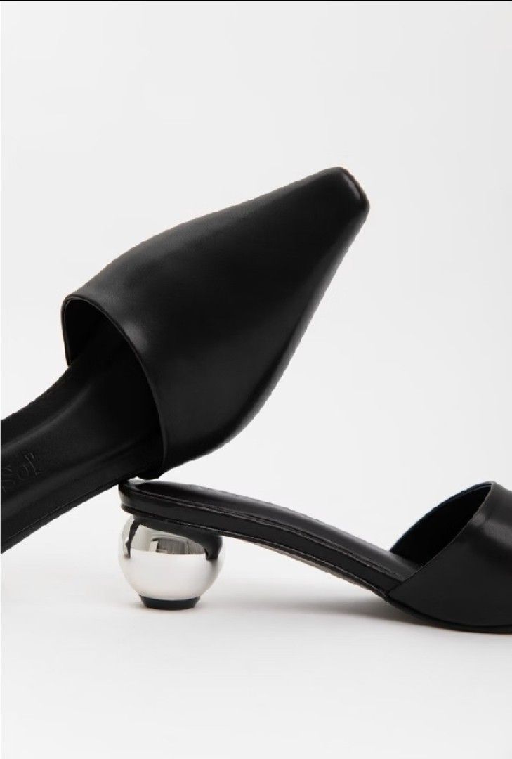 Amara Sol Black Slip-On Mules with Silver Ball Heel (Category: Flats & Sandals) located in San Mateo. Submitted by reyshel08 (Listing ID 1468010693, Image 1). Description: Amara Sol black slip-on mules in size 36. Pointed toe design paired with a unique metallic silver ball heel. Made of smooth black synthetic or leather-like upper material. Comes in the original yellow Amara Sol box along with a matching dust bag. Non-slip sole underneath..