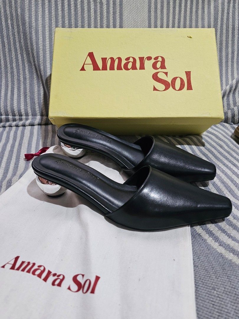 Amara Sol Black Slip-On Mules with Silver Ball Heel (Category: Flats & Sandals) located in San Mateo. Submitted by reyshel08 (Listing ID 1468010693, Image 3). Description: Amara Sol black slip-on mules in size 36. Pointed toe design paired with a unique metallic silver ball heel. Made of smooth black synthetic or leather-like upper material. Comes in the original yellow Amara Sol box along with a matching dust bag. Non-slip sole underneath..