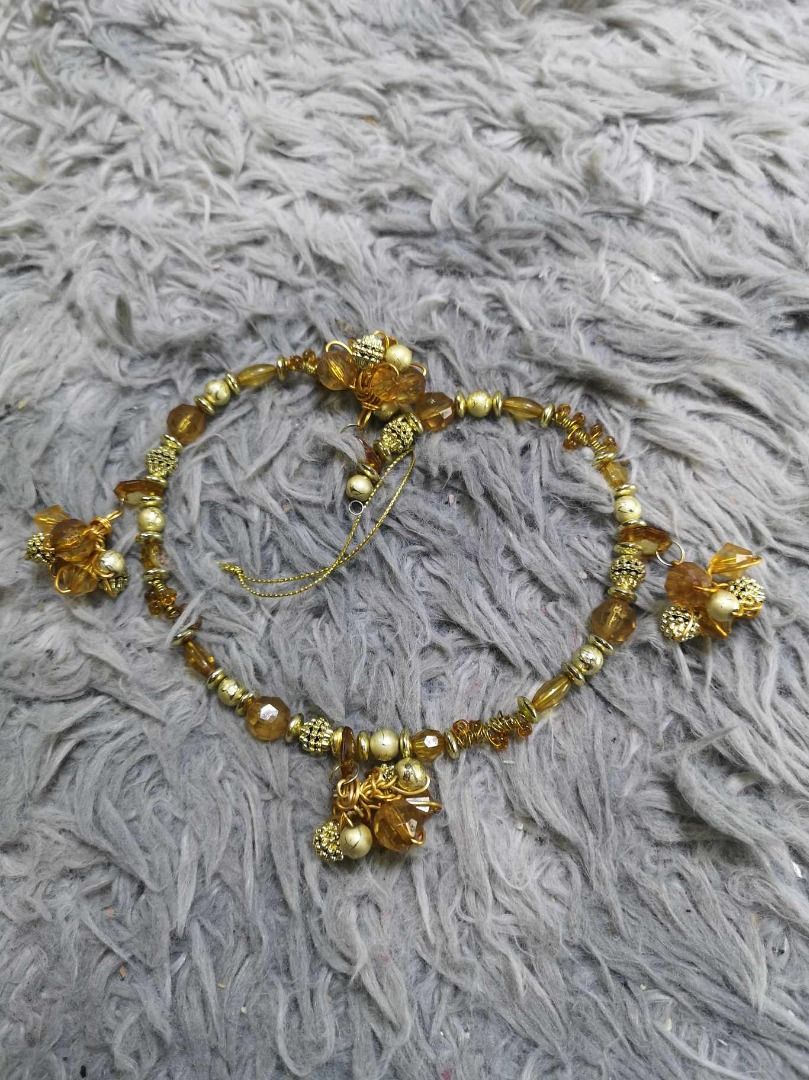 Amber Colored Crystal Beads With Decorative Dangling Charm Bracelet (Category: Bracelets) located in Santa Cruz. Submitted by jmy_surplus.2 (Listing ID 1467904205, Image 1). Description: Size : L - 10 W - 0.4 Color : Amber Type : Bracelet Brand : No Brand Material : Jade Style : Amber Color Bracelet LG 117 JMY3 Batch #225.