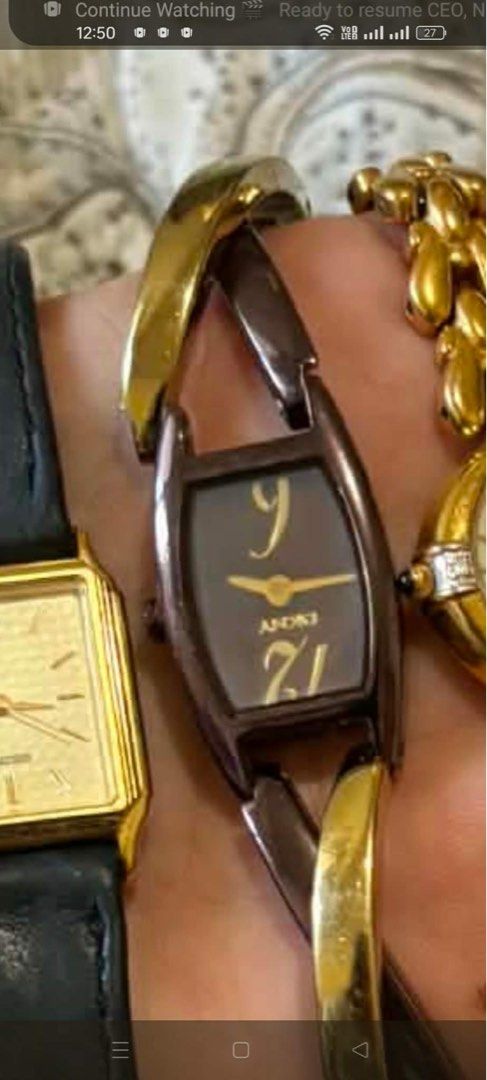 Andaki Vintage Bangle Watch with Unique Curved Case (Category: Women's Watches) located in Zamboanga. Submitted by mysticcat_fd0d15 (Listing ID 1467908226, Image 1). Description: - Brand: Andaki - Dial: Brown rectangular curved dial with gold hands and large numeral markers at the top and bottom - Strap: Unique bangle-style strap in mixed gold and bronze tones - Fit: Wears comfortably like a bracelet on the wrist - Note: Battery status is unknown