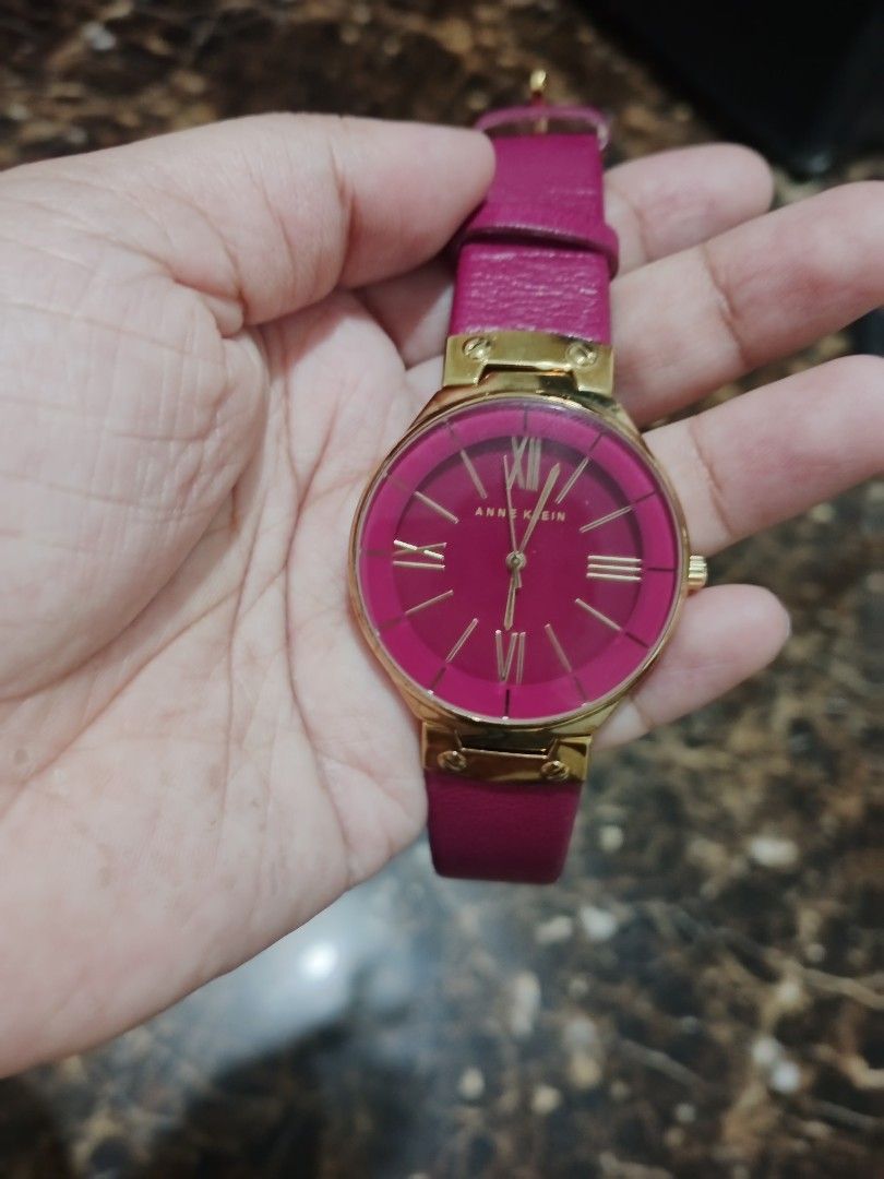 Anne Klein Watch (Category: Luxury Watches) located in San Pedro. Submitted by matchasparkles (Listing ID 1467856953, Image 1). Description: ⌚ Key Specifications Model: Anne Klein AK-1612MAMA Colorway: Vibrant magenta / fuchsia dial and leather strap paired with a polished gold-tone case. Dial Details: Clean minimalist layout featuring a mix of gold-tone Roman numerals (at XII, III, VI, and IX) and stick index markers. Case Width: Approximately 3