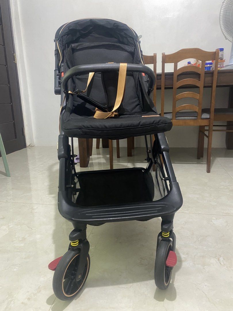 APRUVA AXEL DELUXXE REVERSIBLE COMPACT STROLLER (Category: Strollers) located in Quezon City. Submitted by zhellar (Listing ID 1467900610, Image 3). Description: - Brand: Apruva Stroller - Color: Sleek black with premium gold trim and straps - Canopy: Large canopy for maximum sun protection - Storage: Generous bottom basket for diaper bags and groceries - Safety: Secure harness equipped with comfortable shoulder pads - Mobility: Smooth-rolling wh