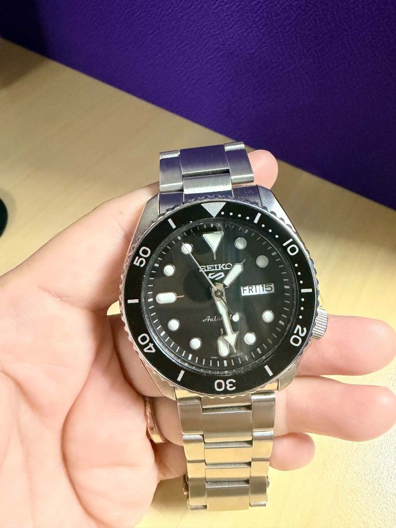 Auth Seiko 5 Sports Automatic Diver Watch (Category: Men's Watches) located in Manila. Submitted by luxtimeless (Listing ID 1468030734, Image 1). Description: - Brand: Seiko 5 Sports Automatic Dive Watch - Dial: Classic black with day-date window at 3 o'clock - Movement: Reliable 4R36 automatic movement visible via exhibition case back - Design: Rotating bezel and durable steel bracelet strap - Condition: Normal wear on the clasp and case from da