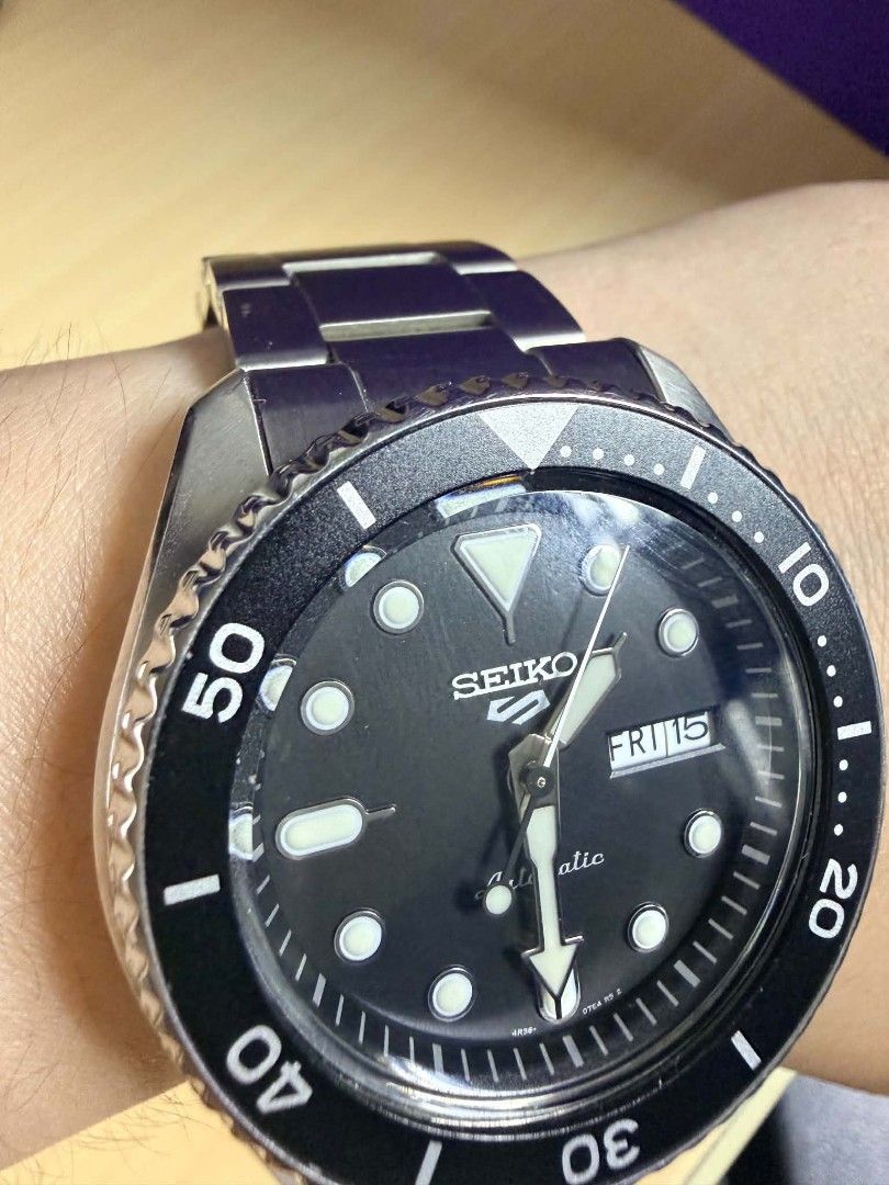 Auth Seiko 5 Sports Automatic Diver Watch (Category: Men's Watches) located in Manila. Submitted by luxtimeless (Listing ID 1468030734, Image 2). Description: - Brand: Seiko 5 Sports Automatic Dive Watch - Dial: Classic black with day-date window at 3 o'clock - Movement: Reliable 4R36 automatic movement visible via exhibition case back - Design: Rotating bezel and durable steel bracelet strap - Condition: Normal wear on the clasp and case from da
