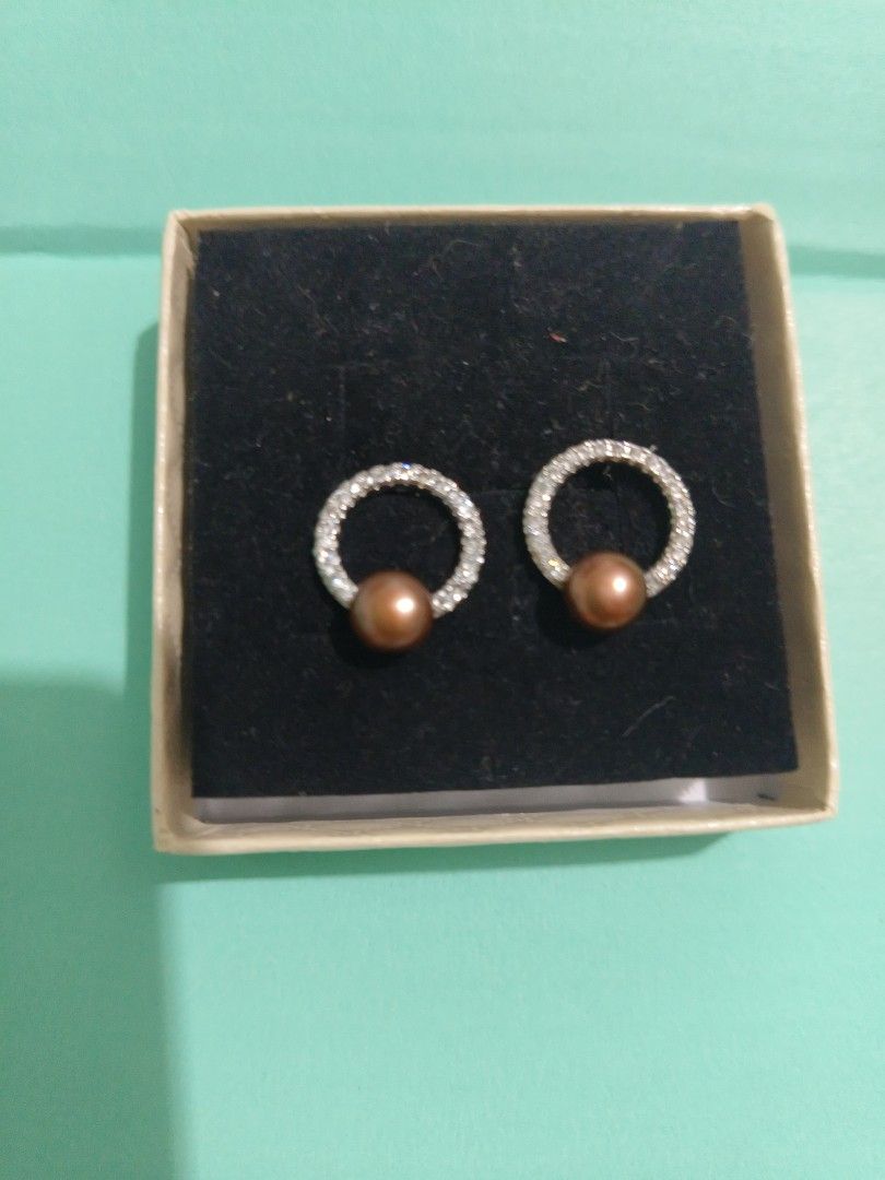 Authentic Freshwater Pearl and rhinestone circle stud earrings (Category: Earrings) located in Antipolo. Submitted by shopbyey (Listing ID 1467943471, Image 1). Description: - Authentic freshwater pearls from Palawan. - Design: Round stud earrings with hanging small brown freshwater pearls encased in sparkly rhinestone rings - Hardware: Micron Silver-tone metal with secure standard post closure - Inclusions: Comes with original presentation box -