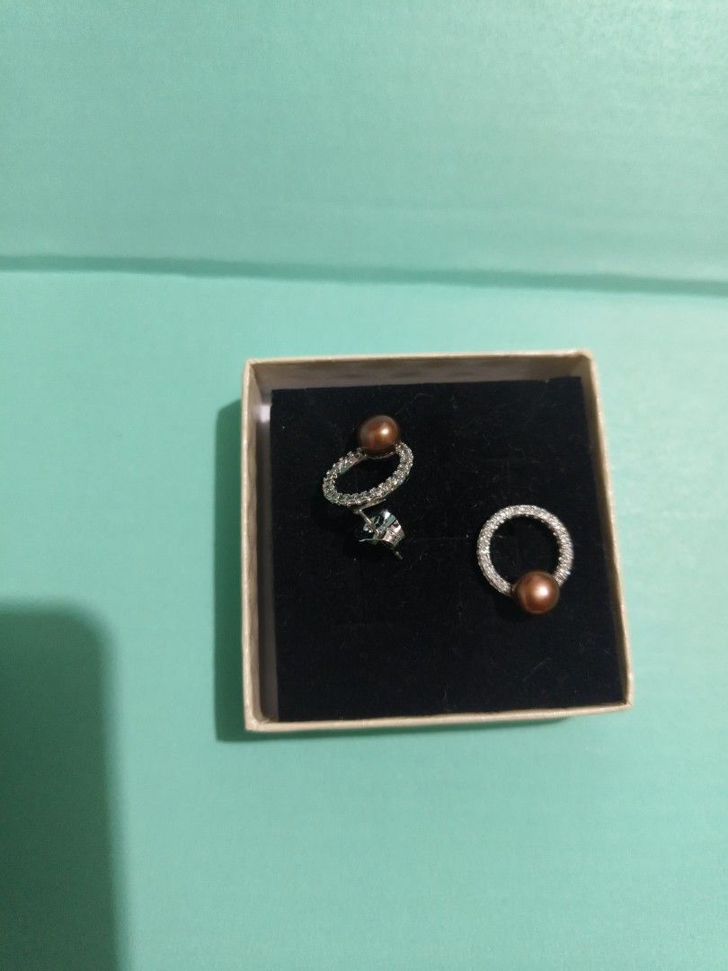 Authentic Freshwater Pearl and rhinestone circle stud earrings (Category: Earrings) located in Antipolo. Submitted by shopbyey (Listing ID 1467943471, Image 2). Description: - Authentic freshwater pearls from Palawan. - Design: Round stud earrings with hanging small brown freshwater pearls encased in sparkly rhinestone rings - Hardware: Micron Silver-tone metal with secure standard post closure - Inclusions: Comes with original presentation box -