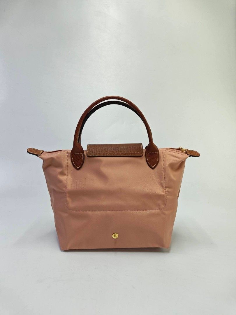 Authentic Longchamp Le Pliage Small Short Handle Top Handle Bag - Pink Tea (Category: Tote Bags) located in Quezon City. Submitted by hollowwillow (Listing ID 1467859083, Image 3). Description: - Authentic Longchamp Le Pliage Top Handle Bag - Color: Charming pink nylon with signature brown leather flap and handles - Hardware: Gold-tone snap closure and zipper - Interior: Clean lining with convenient slip pockets - Features: Iconic foldable design
