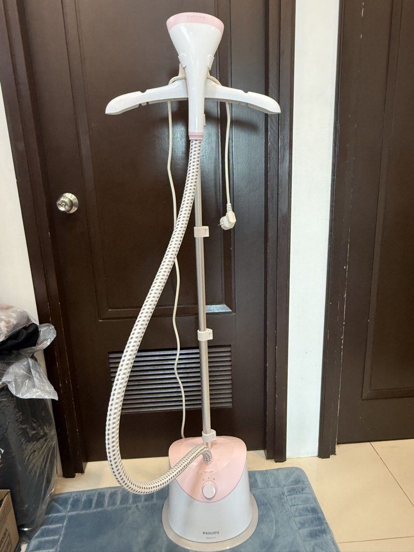 Authentic Philips EasyTouch Garment Steamer (Category: Irons & Steamers) located in Manila. Submitted by inlababoqueen (Listing ID 1467995390, Image 2). Description: - Model: Philips EasyTouch Standing Garment Steamer - Color: White and Pink - Features: Built-in clothes hanger, telescopic pole, and steam hose - Control: Simple rotary dial on the base with adjustable steam settings - Power: Ready-to-use with attached plug - Condition: Excellent wo