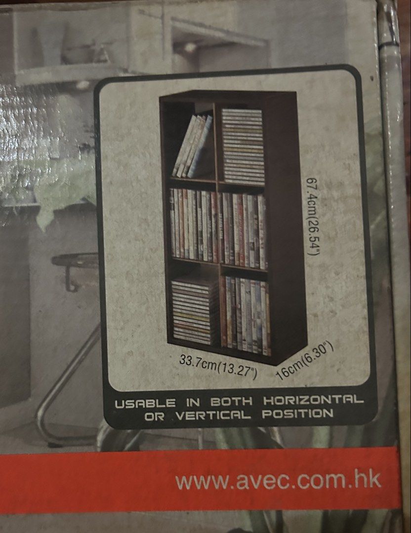 AVEC 120CD/60DVD Framework Storage Module 05701 (Category: CDs & DVDs) located in Caloocan City. Submitted by dillydadi67 (Listing ID 1467987063, Image 2). Description: - AVEC Storage Module (Model 05701) for CDs and DVDs - Capacity: Holds up to 120 CDs or 60 DVDs - Dimensions: 67.4cm (L) x 33.7cm (W) x 16cm (H) - Design: Dark wood finish with natural wood inner boards and white back panel - Versatile: Can be positioned both horizontally and vert