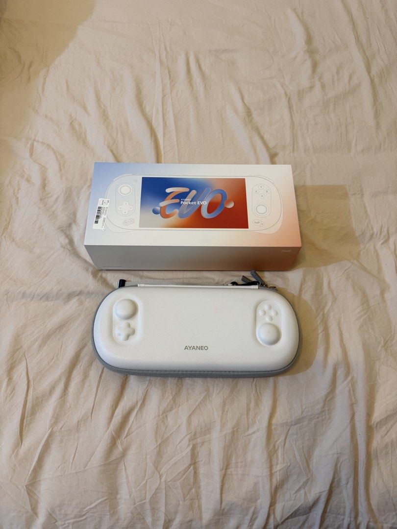 Ayaneo Pocket EVO (white) (Category: Others) located in Taguig. Submitted by prelovedby.em (Listing ID 1468020112, Image 1). Description: Inclusion: 1. 64 gb memory card with some nintendo switch, 3ds, ds, ps2 emulation games 2. Case, box, charger 3. Thumb grip no issue, rfs: too many gadgets.