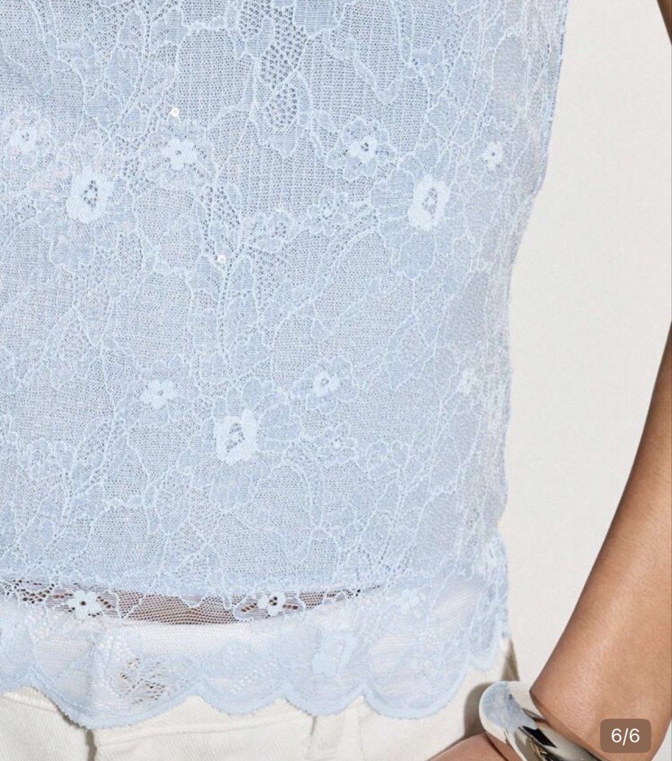 Baby blue lace halter top with subtle shimmer (Category: Sleeveless) located in Manila. Submitted by closetnco (Listing ID 1467876751, Image 3). Description: - Color: Light blue - Design: Floral lace pattern with subtle sequins - Details: Thin string tie at the back of the neck, scalloped hem - Condition: Brand new, unworn, tags removed - Perfect for casual outings or dates.