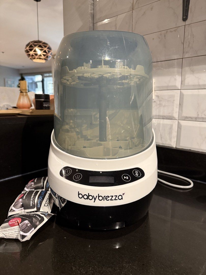 Baby Brezza Bottle Washer Pro with Detergent Tablets (Category: Breastfeeding & Bottle Feeding) located in Quezon City. Submitted by maffyyy (Listing ID 1468056656, Image 2). Description: - Baby Brezza Bottle Washer Pro (White/Black with clear cover) - Automatically washes and sanitizes baby bottles - Features a front digital control panel - Includes 2 unopened packs of Baby Brezza detergent tablets - Ultimate time-saver for busy parents - Condit