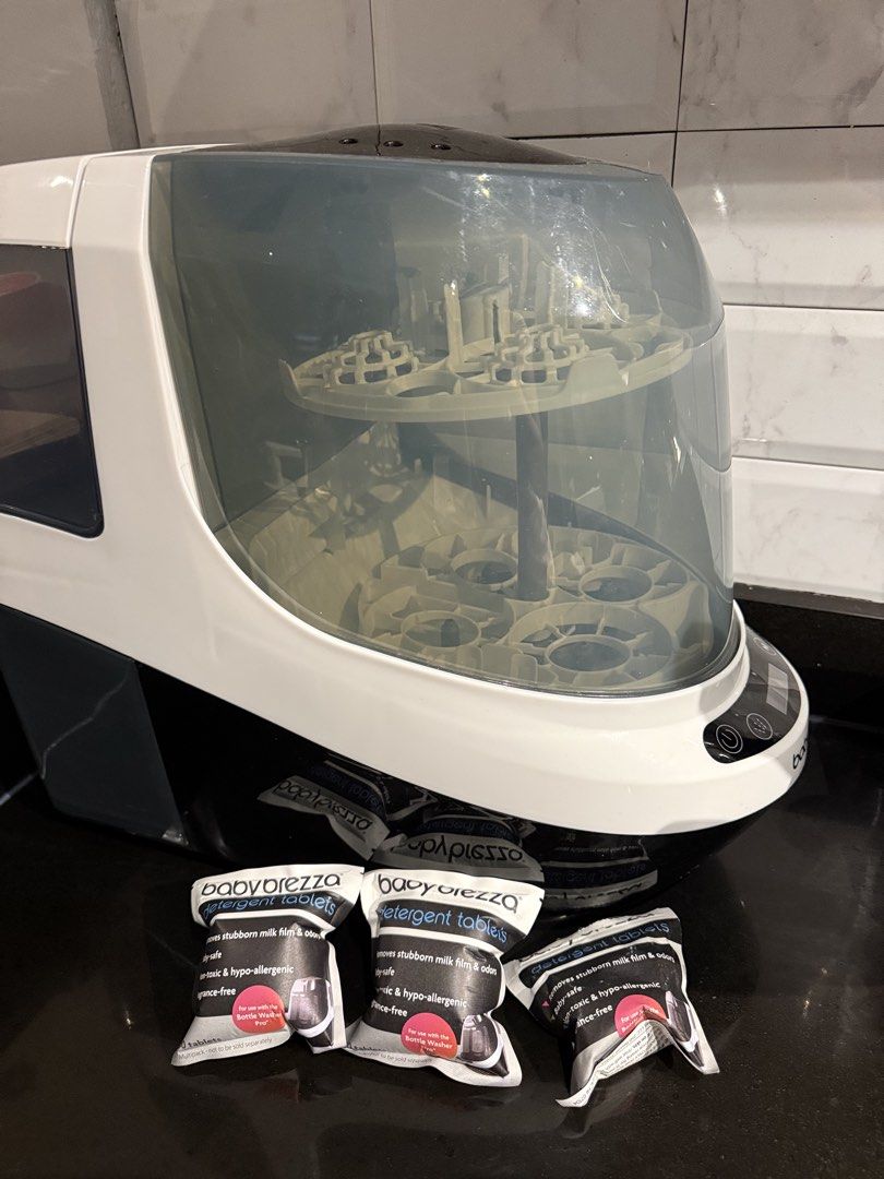 Baby Brezza Bottle Washer Pro with Detergent Tablets (Category: Breastfeeding & Bottle Feeding) located in Quezon City. Submitted by maffyyy (Listing ID 1468056656, Image 1). Description: - Baby Brezza Bottle Washer Pro (White/Black with clear cover) - Automatically washes and sanitizes baby bottles - Features a front digital control panel - Includes 2 unopened packs of Baby Brezza detergent tablets - Ultimate time-saver for busy parents - Condit