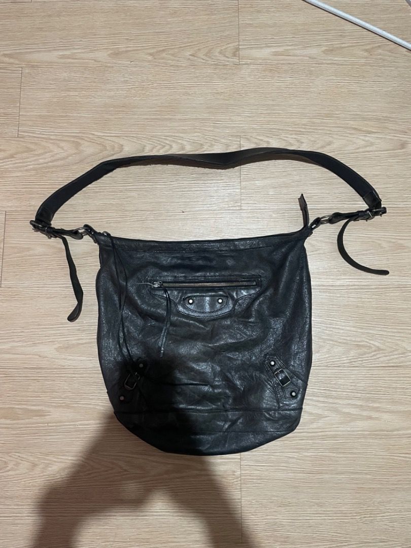 Balenciaga Black Leather Motorcycle Hobo Crossbody Bag (Category: Luxury Bags & Wallets) located in Sorsogon. Submitted by solayram0114595 (Listing ID 1467940407, Image 1). Description: - Brand: Balenciaga - Color: Classic Black - Material: Genuine distressed leather with natural wear - Hardware: Iconic motorcycle metal details and studs - Compartments: Roomy main interior with front zipper pocket - Strap: Adjustable shoulder strap with metal buc